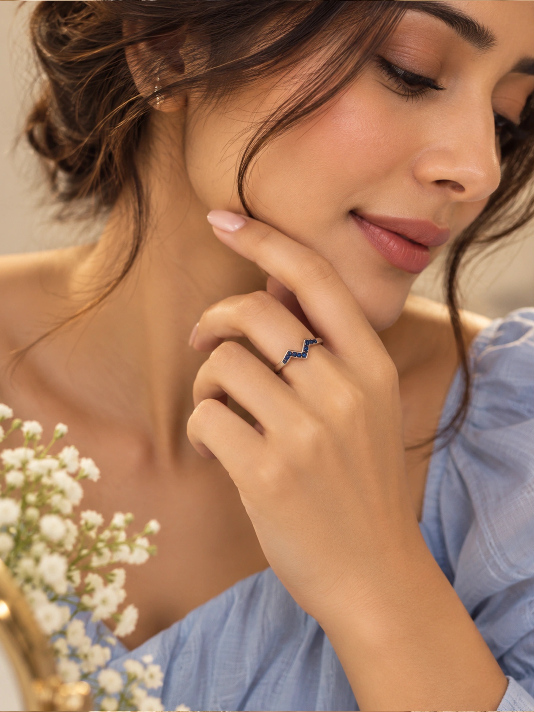 Close-up of handcrafted 925 sterling silver blue stone wave ring